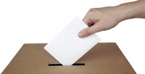 close up of hand and voting ballot